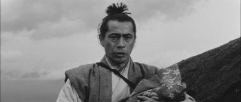 Movie still from “Samurai Rebellion” (1967), directed by Masaki Kobayashi – A man with a long black hair and a long beard; Close Up shot, Low angle