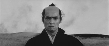Movie still from “Samurai Rebellion” (1967), directed by Masaki Kobayashi – An old photo of a man with a shaved head; Close Up shot, Low angle