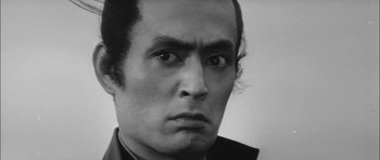 Movie still from “Samurai Rebellion” (1967), directed by Masaki Kobayashi – Black and white photograph of a man's face; Close Up shot, Low angle