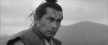 Movie still from “Samurai Rebellion” (1967), directed by Masaki Kobayashi – A man in a robe with a forehead tattoo; Close Up shot, Low angle