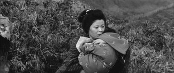 Movie still from “Samurai Rebellion” (1967), directed by Masaki Kobayashi – An older woman holding a jacket in her arms; Medium shot, High angle