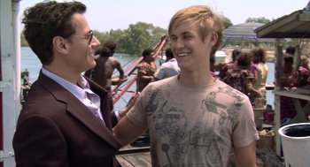 Movie still from “Sanctum” (2011), directed by Alister Grierson – A man standing next to another man on a boat; Medium shot, Over the shoulder angle