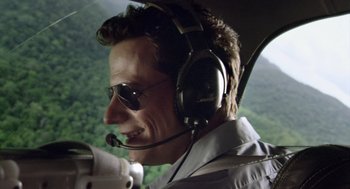 Movie still from “Sanctum” (2011), directed by Alister Grierson – A man with a microphone and headphones in a helicopter; Close Up shot, Low angle