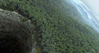 Movie still from “Sanctum” (2011), directed by Alister Grierson – A view from a helicopter of a forest of green trees; Extreme Wide shot, Overhead angle