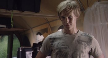 Movie still from “Sanctum” (2011), directed by Alister Grierson – A man with blonde hair and a white t - shirt; Close Up shot, Over the shoulder angle