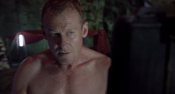 Movie still from “Sanctum” (2011), directed by Alister Grierson – A man with a beard is looking at the camera; Close Up shot, Over the shoulder angle