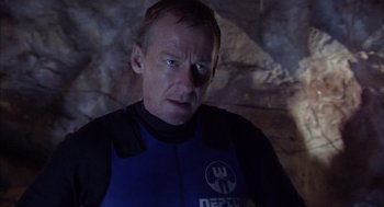 Movie still from “Sanctum” (2011), directed by Alister Grierson – A man in a wetsuit looking at the camera; Close Up shot, Over the shoulder angle