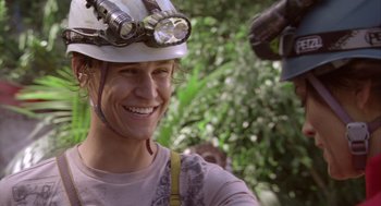 Movie still from “Sanctum” (2011), directed by Alister Grierson – A woman wearing a hard hat smiles for the camera; Close Up shot, Over the shoulder angle