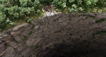 Movie still from “Sanctum” (2011), directed by Alister Grierson – A group of people rappelling down a cliff; Extreme Wide shot, Overhead angle