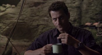 Movie still from “Sanctum” (2011), directed by Alister Grierson – A man is holding a cup of coffee; Close Up shot, Over the shoulder angle