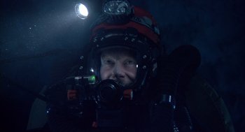 Movie still from “Sanctum” (2011), directed by Alister Grierson – A man in a scuba suit with a helmet on; Close Up shot, Overhead angle