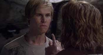 Movie still from “Sanctum” (2011), directed by Alister Grierson – A young man looking into a mirror while holding his finger to his ear; Close Up shot, Over the shoulder angle
