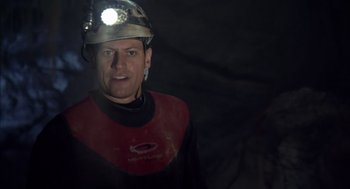 Movie still from “Sanctum” (2011), directed by Alister Grierson – A man wearing a hard hat with a light on his head; Close Up shot, Low angle