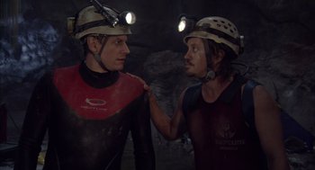 Movie still from “Sanctum” (2011), directed by Alister Grierson – Two people in a cave with helmets on; Close Up shot, Over the shoulder angle