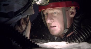 Movie still from “Sanctum” (2011), directed by Alister Grierson – A person with a helmet on; Close Up shot, Over the shoulder angle