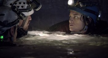 Movie still from “Sanctum” (2011), directed by Alister Grierson – A man and a woman in the water with headlamps on; Close Up shot, Over the shoulder angle