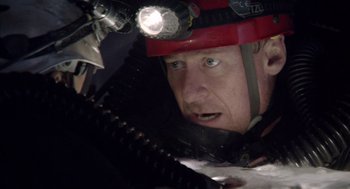 Movie still from “Sanctum” (2011), directed by Alister Grierson – A person with a helmet on; Close Up shot, Low angle