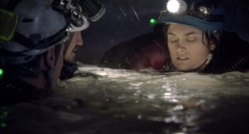 Movie still from “Sanctum” (2011), directed by Alister Grierson – A man and a woman in the water with a helmet on their head; Close Up shot, Overhead angle