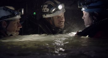 Movie still from “Sanctum” (2011), directed by Alister Grierson – A man in a helmet is in a body of water; Wide shot, Overhead angle