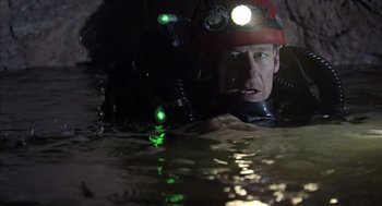 Movie still from “Sanctum” (2011), directed by Alister Grierson – A man in a helmet is in the water; Medium shot, High angle