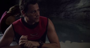 Movie still from “Sanctum” (2011), directed by Alister Grierson – A person sitting on the ground with his hands crossed; Close Up shot, Over the shoulder angle