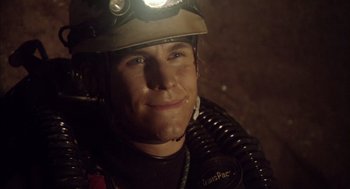 Movie still from “Sanctum” (2011), directed by Alister Grierson – A man wearing a helmet with a light on his head; Close Up shot, Overhead angle