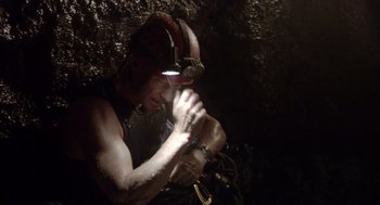 Movie still from “Sanctum” (2011), directed by Alister Grierson – A man with a helmet on his head is holding a rope; Medium shot, Low angle