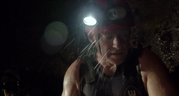 Movie still from “Sanctum” (2011), directed by Alister Grierson – A man wearing a hard hat with a light on his head; Close Up shot, Low angle
