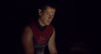 Movie still from “Sanctum” (2011), directed by Alister Grierson – A person wearing a wetsuit; Close Up shot, Low angle