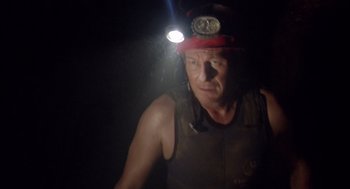 Movie still from “Sanctum” (2011), directed by Alister Grierson – A man with a red hat and a light on his head; Close Up shot, Low angle