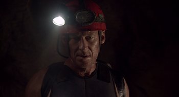 Movie still from “Sanctum” (2011), directed by Alister Grierson – A person wearing a hard hat with a light on; Close Up shot, Low angle