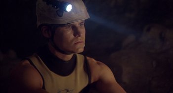 Movie still from “Sanctum” (2011), directed by Alister Grierson – A man wearing a hard hat with a light on his head; Close Up shot, Low angle