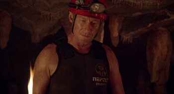 Movie still from “Sanctum” (2011), directed by Alister Grierson – A man wearing a hard hat in a cave; Close Up shot, Over the shoulder angle