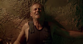 Movie still from “Sanctum” (2011), directed by Alister Grierson – A man in a wetsuit is crying in a cave; Close Up shot, Overhead angle