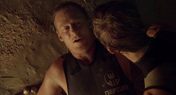 Movie still from “Sanctum” (2011), directed by Alister Grierson – A man and a woman in wet suits in a cave; Close Up shot, Over the shoulder angle