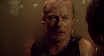 Movie still from “Sanctum” (2011), directed by Alister Grierson – A person in a black shirt; Close Up shot, High angle