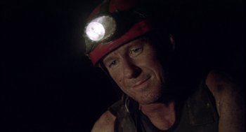 Movie still from “Sanctum” (2011), directed by Alister Grierson – A person wearing a hard hat with a light on it; Close Up shot, Low angle