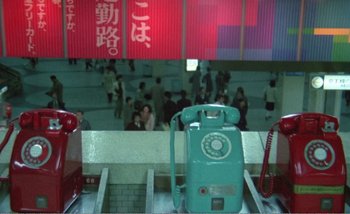 Movie still from “Sans Soleil” (1983), directed by Chris Marker – An old phone is sitting on a platform; Extreme Wide shot, High angle