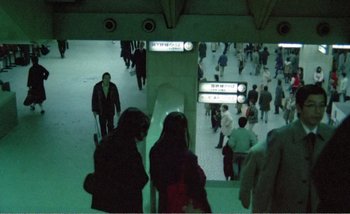 Movie still from “Sans Soleil” (1983), directed by Chris Marker – A group of people walking in a subway station; Extreme Wide shot, High angle