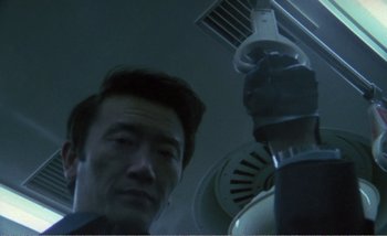 Movie still from “Sans Soleil” (1983), directed by Chris Marker – A person looking at the camera; Close Up shot, Low angle