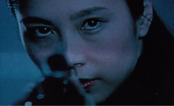 Movie still from “Sans Soleil” (1983), directed by Chris Marker – A person's face in the dark; Extreme Close Up shot, Low angle