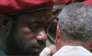 Movie still from “Sans Soleil” (1983), directed by Chris Marker – A person wearing a hat; Close Up shot, Over the shoulder angle