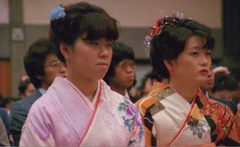 Movie still from “Sans Soleil” (1983), directed by Chris Marker – A group of young women in traditional japanese clothing; Close Up shot, Low angle