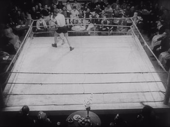 Movie still from “Sanshiro Sugata, Part Two” (1945), directed by Akira Kurosawa – An old photo of a boxing match in a boxing ring; Extreme Wide shot, High angle