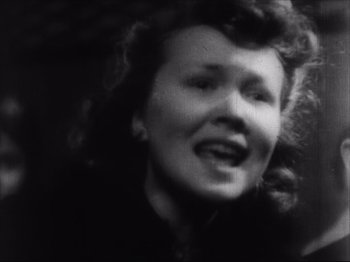 Movie still from “Sanshiro Sugata, Part Two” (1945), directed by Akira Kurosawa – An old photo of a woman smiling for the camera; Close Up shot, Low angle