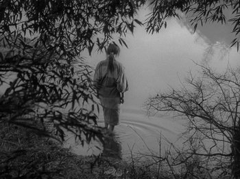 A person walking in the fog on a path