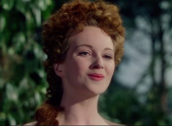 Movie still from “Saraband” (1948), directed by Basil Dearden – A beautiful woman with red curly hair and red lipstick; Close Up shot, Over the shoulder angle