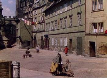 Movie still from “Saraband” (1948), directed by Basil Dearden – An old photo of people walking on the street; Extreme Wide shot, High angle