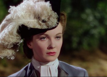 Movie still from “Saraband” (1948), directed by Basil Dearden – A woman with a hat on her head; Close Up shot, Over the shoulder angle