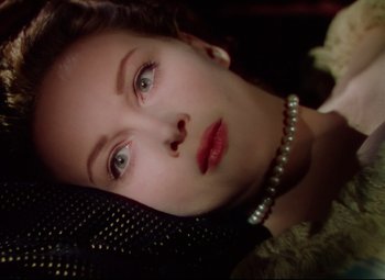 Movie still from “Saraband” (1948), directed by Basil Dearden – A person wearing a pearl necklace; Close Up shot, Overhead angle